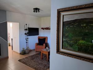 a living room with a painting and a chair at lugar del pazo nª9-albeos in Albeos