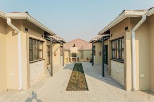 a row of houses with a courtyard in the middle at Beck Apartments - Kitwe in Kitwe