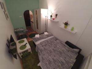 Habitación pequeña con cama y espejo. en Sleep and Go Pedja en Belgrado