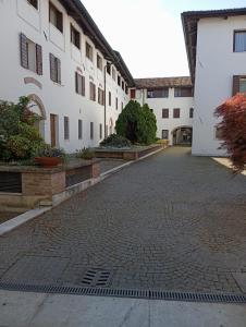 a cobblestone street in front of a white building at CasaMirandola in Vicenza