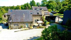 an aerial view of a large stone house at Green Farm Stables in Ashbourne