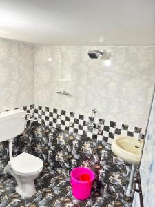 a bathroom with a toilet and a sink at P&P Cozy Corner in Cola