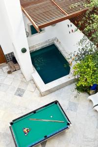 a pool with a ping pong table on a patio at bayt el yemin in Kasbah