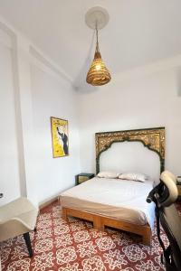 a bedroom with a bed and a chair and a lamp at bayt el yemin in Kasbah +17 photos