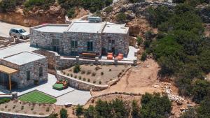 an aerial view of a stone house with a garden at Vounara Houses in Artemonas