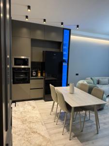 a kitchen and dining room with a table and chairs at family-haven in Tirana