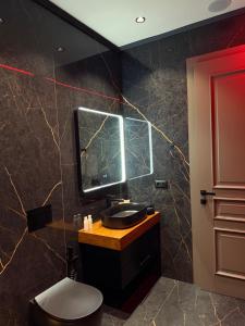 a bathroom with a sink and a mirror at family-haven in Tirana +20 photos