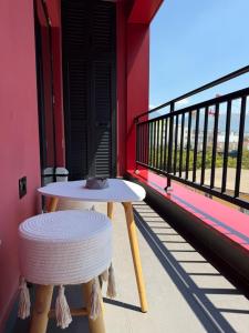 a table and stool sitting on a balcony at family-haven in Tirana