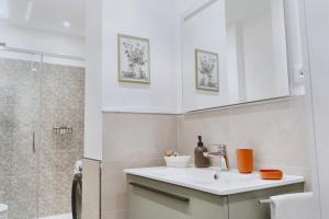 a bathroom with a sink and a shower at My Tuscany Green Apartment in San Quirico dʼOrcia +20 photos