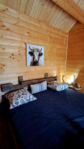 a bedroom with a bed with a picture of a cow at Zum Herz in Charlotenburg