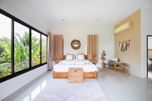 a bedroom with a bed and a large window at The Orange Villa Near Beach in Kamala Beach +102 photos