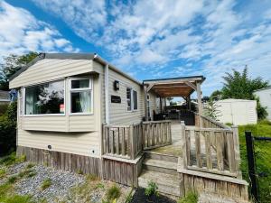 a tiny house with a porch and a deck at Beach Resort Kamperland - 1152 in Kamperland