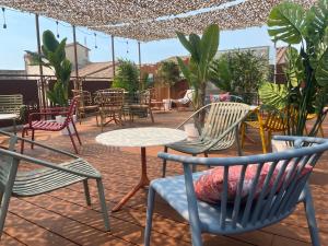 an outdoor patio with chairs and tables and chairs at Logis Hôtel Le Glacier in Orange