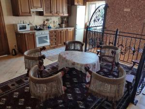 a kitchen with a table and four chairs at Пентхаус РіОНі Трускавець in Truskavets +17 photos