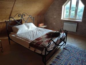 a bedroom with a bed with a wrought iron frame at Пентхаус РіОНі Трускавець in Truskavets