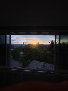a view of a sunset from a balcony at The Reset House Mangalore in Mangalore