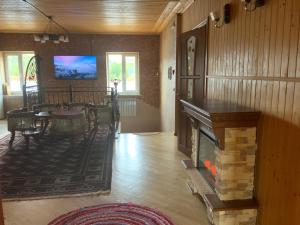 a living room with a fireplace and a dining room at Пентхаус РіОНі Трускавець in Truskavets
