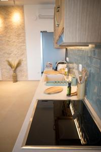 a kitchen with a sink and a counter top at Vounara Houses in Artemonas +135 photos