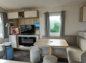 a living room with a table and a fireplace at Beach Resort Kamperland - 1152 in Kamperland