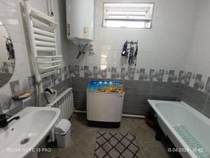 a bathroom with a tub and a toilet and a sink at Baktygul in Karakol +8 photos