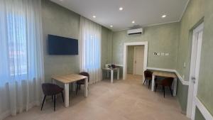 a room with two tables and chairs and a window at Tenuta MAREALE in Anzio