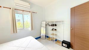 a bedroom with a bed and a glass closet at Temple Light in Ko Phangan