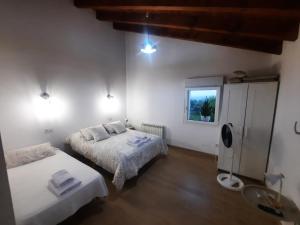 a bedroom with two beds and a window at SEL apartamentos rurales in Sel de la Carrera