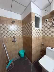 a bathroom with a shower with a toilet and a sink at Zen Studio Paramount in Greater Noida +11 photos