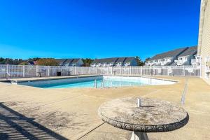 a swimming pool with a table in the middle of it at B BY THE C in Ocean City