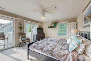 a bedroom with a large bed with a ceiling fan at B BY THE C in Ocean City +32 photos