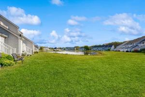 a green yard with a bench in the grass at B BY THE C in Ocean City