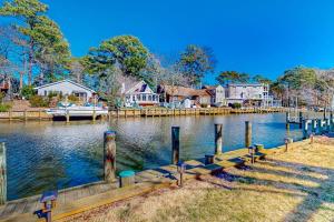 a lake with a dock and houses and a boat at The Sea Captain's Sanctuary in Ocean City
