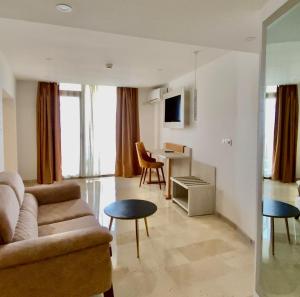 a living room with a couch and a table at Centre Touristique Le Sable in Alger