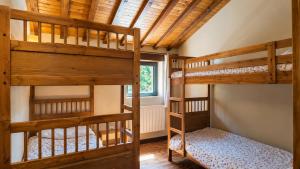 a bedroom with two bunk beds and a window at Las Hayucas in San Roque de Ríomiera