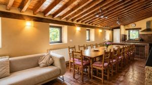 a dining room with a long table and chairs at Las Hayucas in San Roque de Ríomiera