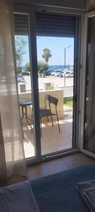 a view of a patio with a table and a chair at Irina Haus in Gerakini