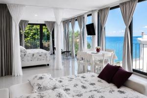 a living room with a couch and a view of the ocean at VILA MOLET KOPER in Koper