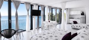 a white living room with a view of the ocean at VILA MOLET KOPER in Koper +90 photos