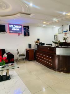 a waiting room with a hair salon with a desk at Hotel Omnisport in Limbe +12 photos