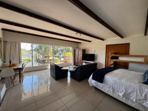 a bedroom with a bed and a table and chairs at Eagles Rest Guest House in Summerstrand