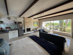 a living room with a couch and a kitchen at Eagles Rest Guest House in Summerstrand