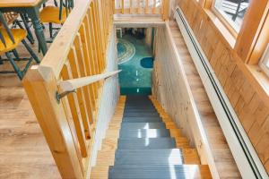 a stairway in a house with a pool at Waterfront cabin w/ outdoor firepit, dock, and lake views - dogs welcome in Greenville