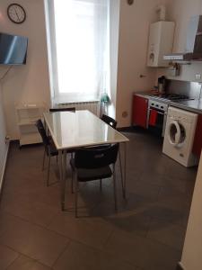a kitchen with a table and chairs in a room at Bastioni VALE in Pescara