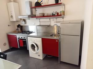 a kitchen with a refrigerator and a washing machine at Bastioni VALE in Pescara