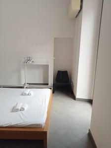 a small room with a bed and a chair at Bastioni VALE in Pescara +1 photo