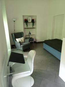 a living room with a couch and a chair at Bastioni VALE in Pescara