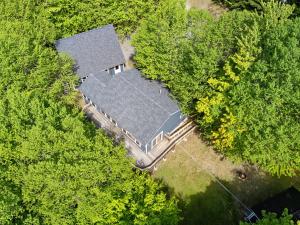an overhead view of a house in the trees at Waterfront cabin w/ outdoor firepit, dock, and lake views - dogs welcome in Greenville +28 photos