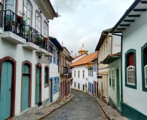 an alley in an old town with colorful buildings at Sobiuai 72 in Ouro Preto