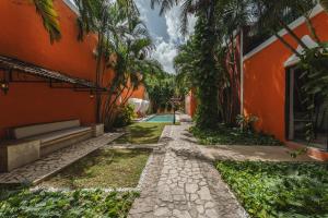 an alley in front of an orange building with a pool at Casa Jade Hotel - Adults Only, Mérida in Mérida