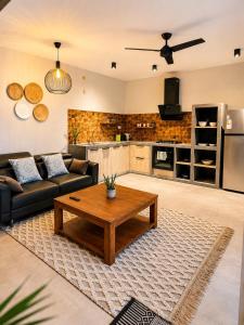 a living room with a couch and a coffee table at Sea Esta in Le Morne